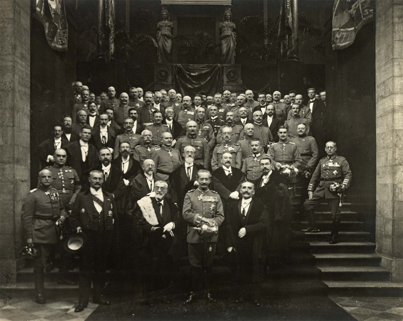 De overdracht van de vernederlandste Universiteit Gent aan de academische overheid, 21 oktober 1916. Beheerder Ernest Haerens bevindt zich rechts op de eerste rij, naast gouverneur-generaal van het Duitse bezettingsbestuur Moritz von Bissing. (Universiteitsbibliotheek Gent)